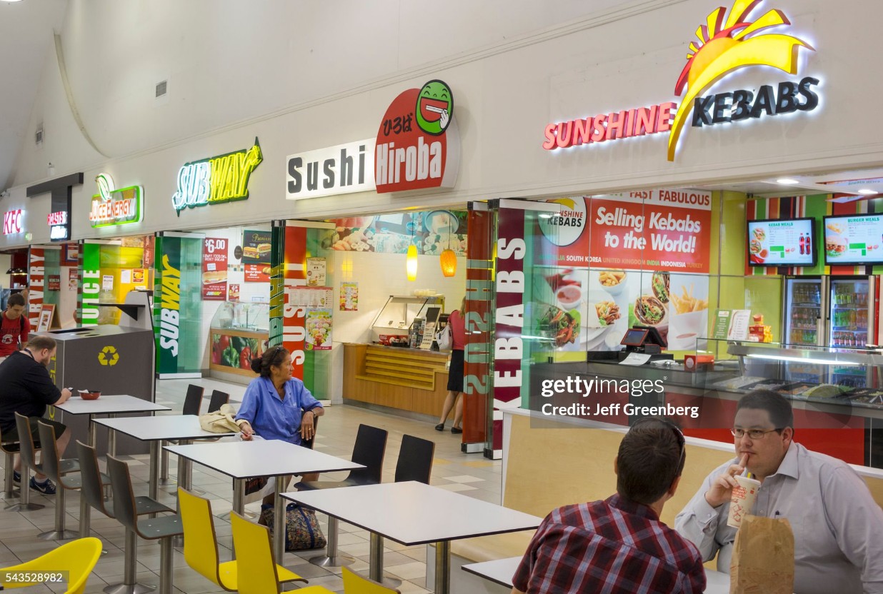 Busy Australian shopping centre food court with several takeaway stalls